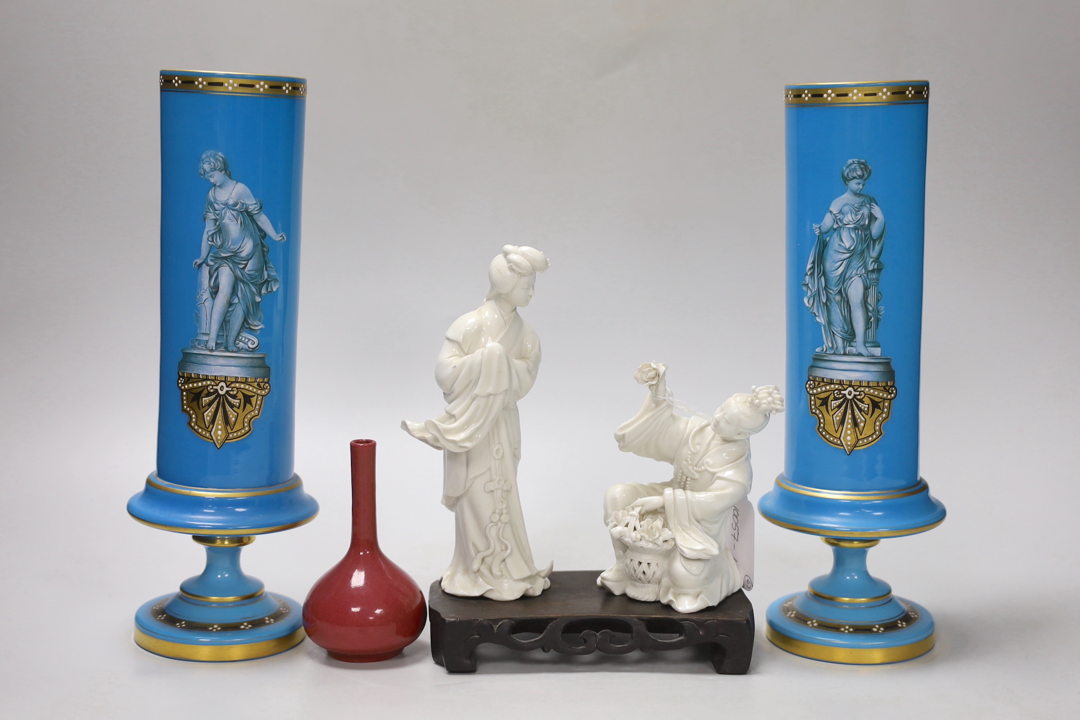 A pair of French enamelled glass vases, two Chinese blanc de chine figures on a stand and a miniature bottle vase, tallest 19cm high